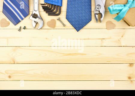 Fathers Day top border of gifts, ties and decor on a natural wood background. Top view with copy space. Stock Photo