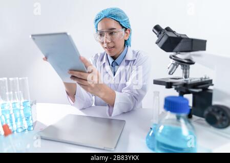 Scientists are working with digital tablet in laboratory Stock Photo