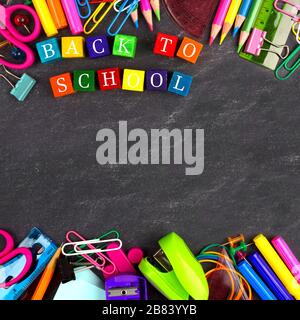 Colorful Back to School wooden blocks with school supplies double border on a blackboard Stock Photo