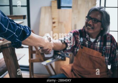 Two carpenters working in shop  wood craftsman Stock Photo
