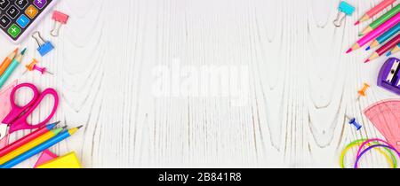 School supplies double side border banner. Top view on a white wood background with copy space. Back to school concept. Stock Photo