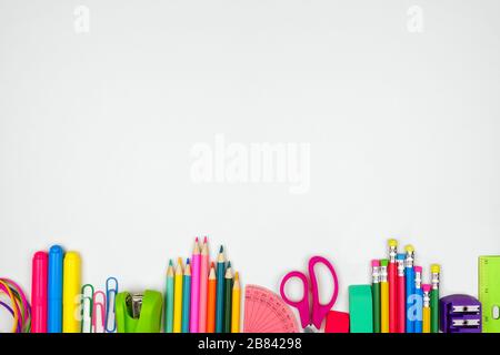 School supplies bottom border. Top view on a white background with copy space. Back to school concept. Stock Photo