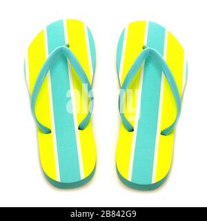 Blue and yellow striped summer flip flops on a white background Stock Photo