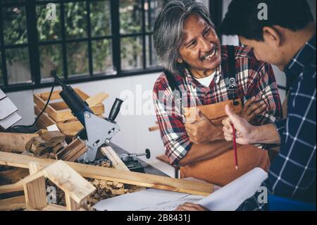Two carpenters working in shop  wood craftsman Stock Photo