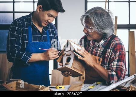 Two carpenters working in shop  wood craftsman Stock Photo