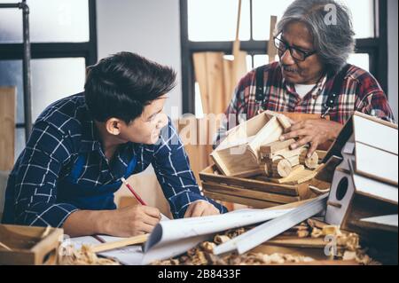 Carpenter working on woodworking machines in carpentry shop. woman works in a carpentry shop. Stock Photo