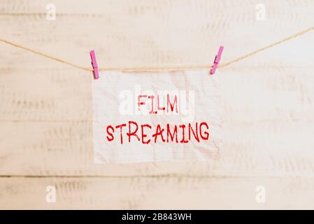 Handwriting text writing Film Streaming. Conceptual photo act of watching sound or video directly from the internet Clothesline clothespin rectangle s Stock Photo