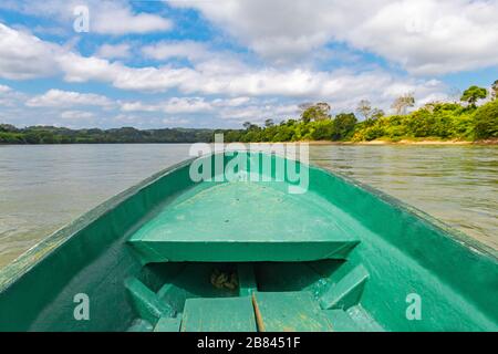 The Usumacinta river, the international border between Guatemala and Mexico, seen from a boat. Boat is sharp, rainforest and riverbank unsharp. Stock Photo