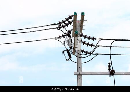 Electric pole power Tangle wire danger, wire electrical energy at street road on sky background Stock Photo