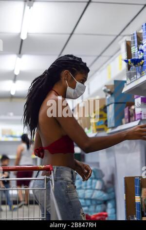 Young woman with face mask last minute shopping in supermarket, a day before the first lockdown in Colombia due to Coronavirus. Stock Photo