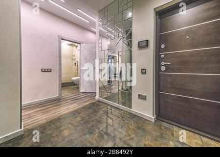 Empty residential house entrance with closed doors build in closets with mirrors Stock Photo