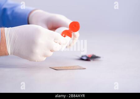 Male hand applying disinfectant to a wipe Stock Photo