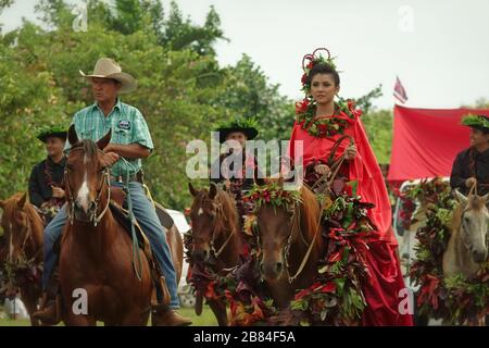 Lihue, Kauai, Hawaii / USA - June 9, 2018: A Pa‘u Princess, representing the island of Hawaii, rides on a horse at the annual King Kamehameha Parade. Stock Photo