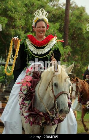 Lihue, Kauai, Hawaii / USA - June 9, 2018: A Pa‘u Princess, representing a Hawaiian island, rides on a horse at the annual King Kamehameha Day Parade. Stock Photo