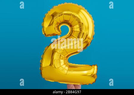 Gold foil number 2 celebration balloon Stock Photo