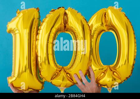 Gold foil number 100 celebration balloon Stock Photo