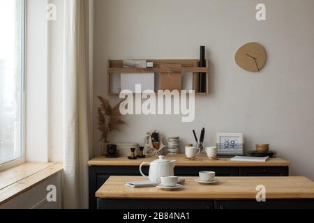 White tea set for tea drinking on served table in kitchen Stock Photo