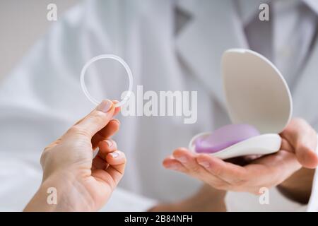 Gynecologist Showing Contraception Ring To Woman And Explaining Contraception And Birth Control Methods Stock Photo