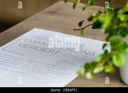 Berlin, Germany. 19th Mar, 2020. The note "Reserved so that Corona loses" is written on a piece of paper blocking a table so that a minimum distance between guests can be maintained in the cafe in the fight against the corona virus. Credit: Jens Kalaene/dpa-Zentralbild/ZB/dpa/17�Թ����� Live News Stock Photo