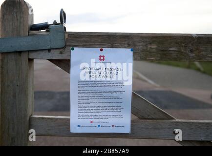 A sign on a footpath near Stonehenge on Salisbury Plain in Wiltshire, where the traditional equinox celebrations inside the stones were cancelled after English Heritage, which manages the attraction, closed the site until May 1 following government advice on coronavirus. Stock Photo