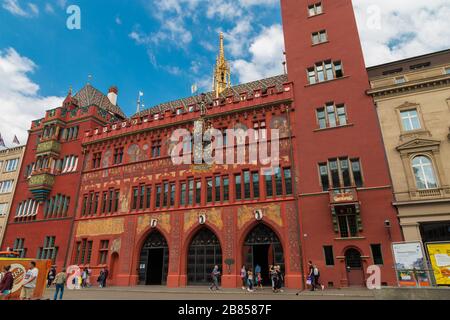 Nice view of the Basel Town Hall dominating the Marktplatz with its red facade, the characteristic tower, frescoes and crenellations. It is the seat... Stock Photo