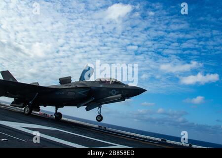 PHILIPPINE SEA (March 18, 2020) An F-35B Lightning II fighter aircraft with Marine Medium Tiltrotor Squadron 265 (Reinforced), 31st Marine Expeditionary Unit (MEU), takes off from the flight deck of amphibious assault ship USS America (LHA 6). America, flagship of the America Expeditionary Strike Group, 31st MEU team, is operating in the U.S. 7th Fleet area of operations to enhance interoperability with allies and partners and serve as a ready response force to defend peace and stability in the Indo-Pacific region. (Official U.S. Marine Corps photo by Cpl. Isaac Cantrell) Stock Photo