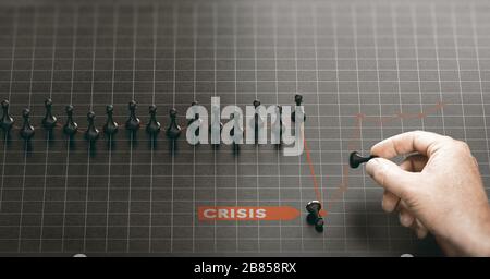 Man moving pawns over a red chart to recover from a crisis. Business continuity plan or disaster recovery concept. Composite image between a hand phot Stock Photo