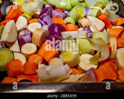 39 Close up and selective focus on fresh and organic vegetables chopped up in a tray ready for roasting in the oven Stock Photo