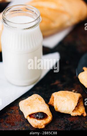 Nice breakfast - milk with croissants on black rustic surface Stock Photo