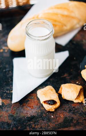 Nice breakfast - milk with croissants on black rustic surface Stock Photo