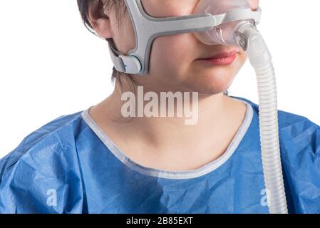 Woman wearing CPAP headgear isolated on a white background Stock Photo