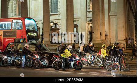 London city transport, Trafalgar Square night time. Commuters leaving central London UK at night. London traffic buses, taxis, cyclists, motorcyclists. Stock Photo
