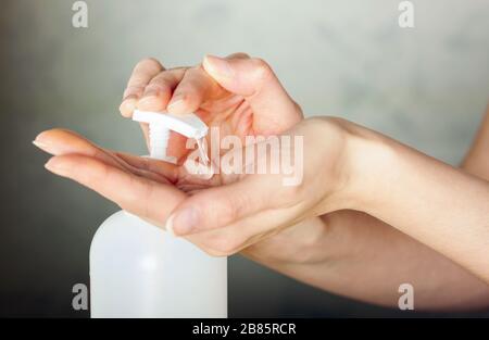 Hand holding antiseptic antibacterial disinfectant isolated on  background. Coronavirus protection Stock Photo