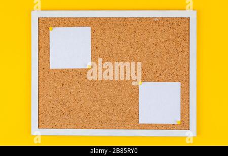 abstract paper note pin on cork board. Blank notes for add text message or design website. sticker note on yellow background Stock Photo