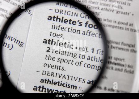 The word or phrase athletic in a dictionary book. Stock Photo