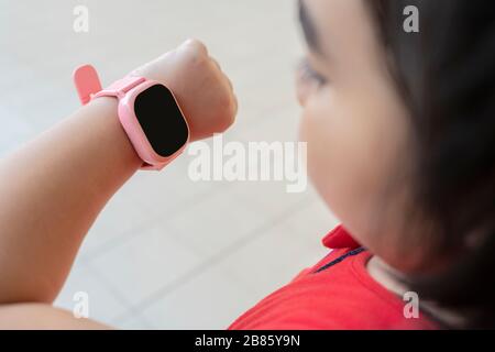 Girls who are using watches, phone calls, contact with parents. There is a GPS signal to be able to track for safety. The screen is black for advertis Stock Photo