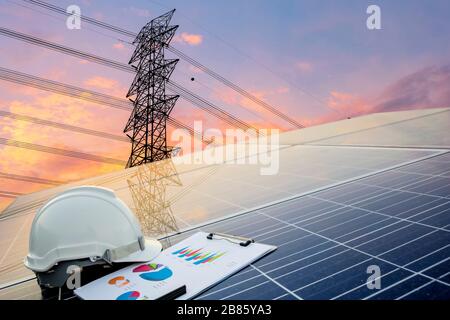 Green energy concept, Electricity station, Close up high voltage power lines at sunset. renewable energy concept with photovoltaic panels, Engineers c Stock Photo