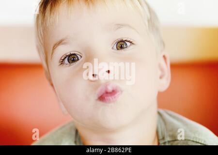 Young boy drinking from glass of fresh water Stock Photo