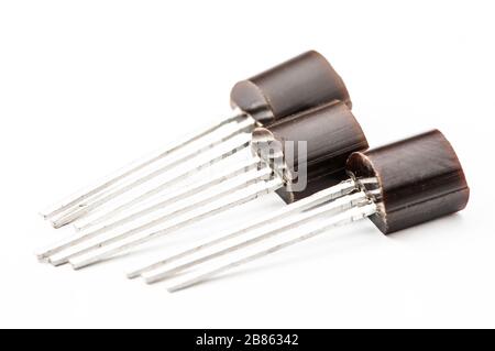 Various electronic components, TO-92 case transistors close-up on white background. Stock Photo