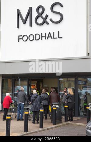 Friday 20th March 2020. Great Yarmouth, UK.  Great Yarmouth shoppers queue for grocery supplies at Marks & Spencer Foodhall in Great yarmouth. Criticsim expressed over inconsistency amongs some stores' special shopping hours for the over 70s and key healthcare workers results when some shoppers are turned away. Stock Photo