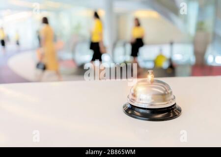 Hotel service bell on a table white glass and simulation hotel background. Concept hotel, travel, room Stock Photo
