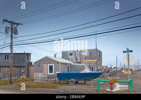 Inuit village with a blue boat and a lamp post at the forefront, Barrow, Alaska Stock Photo