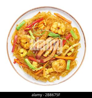 Singapore Mei Fun in plate isolated on white background. Singapore Noodles is chinese cuisine dish with rice noodles, prawns, char siu pork, carrot, r Stock Photo