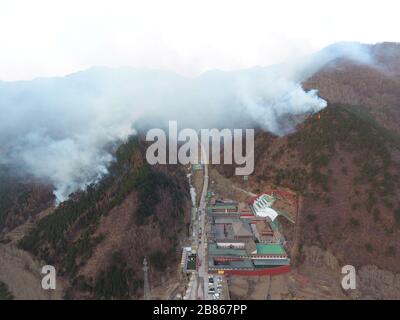 Shanxi, China. 20th Mar, 2020. Aerial photo taken on March 20, 2020 shows the fire area on Mount Wutai in north China's Shanxi Province. A fire has broken out on Mount Wutai, one of China's four sacred Buddhist mountains, in north China's Shanxi Province, the management committee of the scenic area said Friday. The fire broke out on Thursday evening near a parking lot on the mountain and 1,500 people have been sent to the area to battle the fire as of Friday noon, according to the committee. Water cannons and helicopters have also been used to put out the fire. As the b Credit: Xinhua/Alamy Li Stock Photo