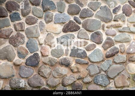 A close up view of a stone and concrete wall Stock Photo