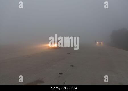 Cars on foggy highway in India Stock Photo