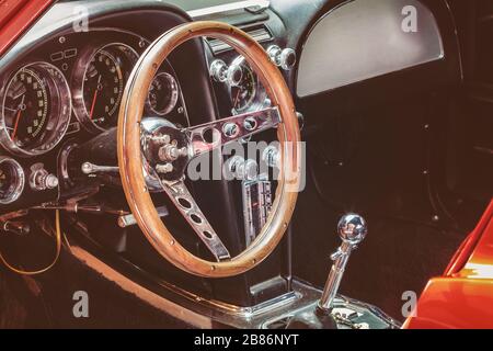 Retro styled image of the dashboard of a classic car with wooden steer Stock Photo