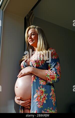 Pregnant woman full term bump exposed 40 weeks 9 months gestation 10 of