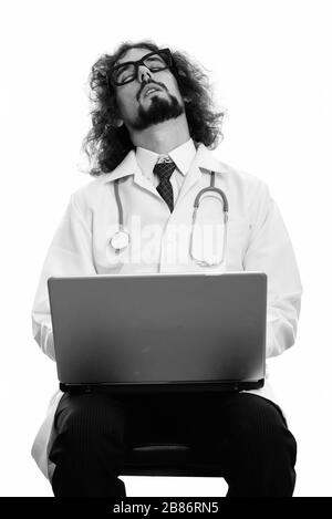 Studio shot of tired man doctor sleeping with laptop Stock Photo