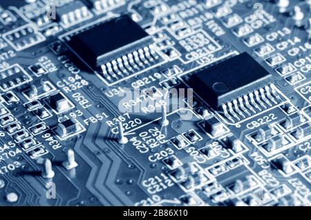 Close-up electronic circuit board with micro chips from a home appliance or laptop electronics and complex devices. Concept of microchips and future t Stock Photo
